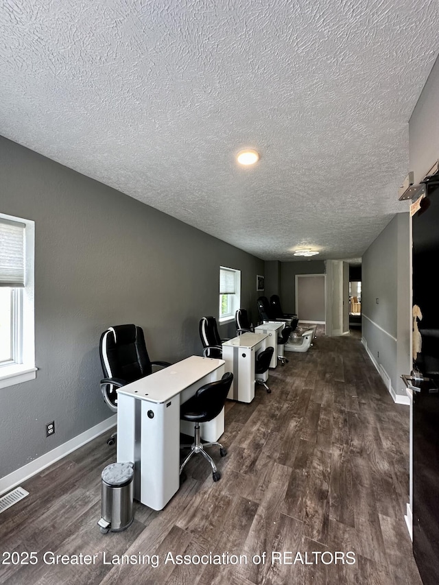 600 E Cavanaugh Rd, Lansing, MI 48910 - office space featuring a textured ceiling, dark wood-style flooring, and baseboards