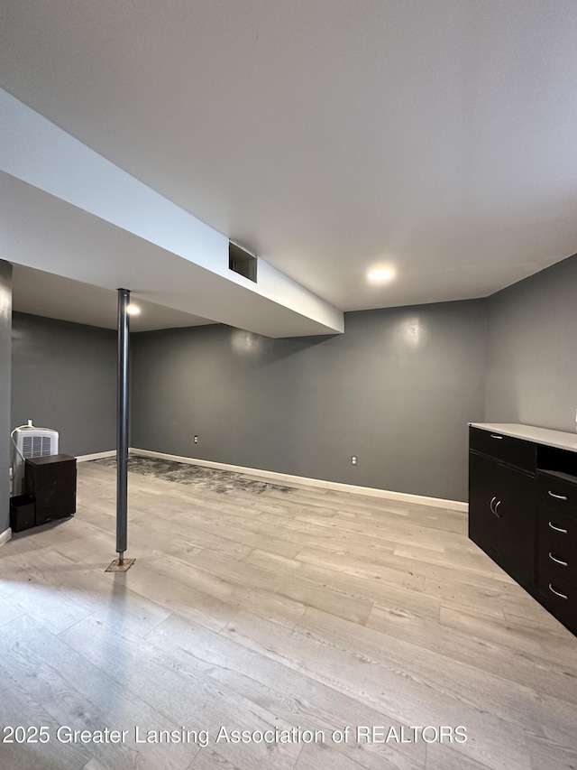 600 E Cavanaugh Rd, Lansing, MI 48910 - finished below grade area featuring light wood finished floors and baseboards