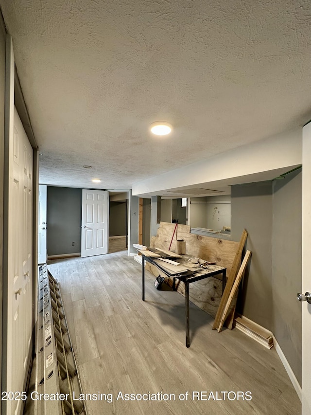 600 E Cavanaugh Rd, Lansing, MI 48910 - dining room with a textured ceiling, wood finished floors, and baseboards