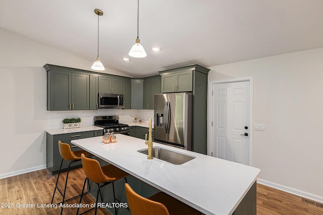 6420 Clise Rd, Bath, MI 48808 - kitchen with stainless steel appliances, a sink, backsplash, light countertops, and baseboards