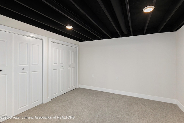 6420 Clise Rd, Bath, MI 48808 - unfurnished bedroom with carpet floors, baseboards, and multiple closets