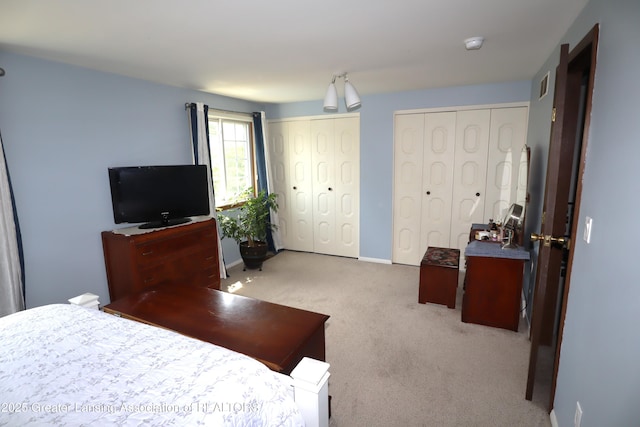 1615 Peppertree Ln, Lansing, MI 48912 - carpeted bedroom featuring two closets and baseboards