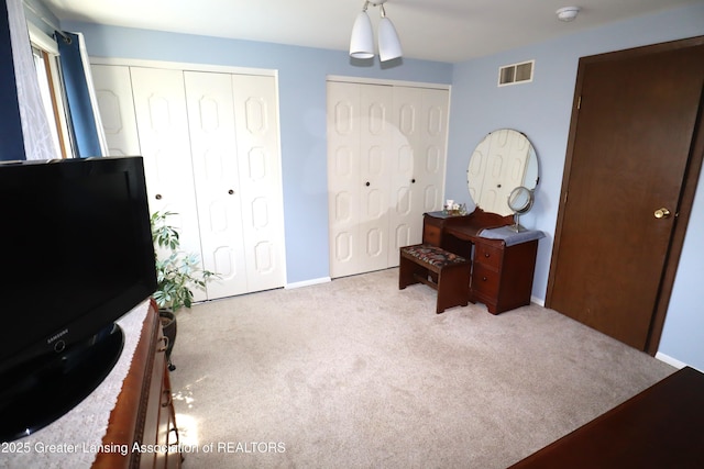 1615 Peppertree Ln, Lansing, MI 48912 - carpeted bedroom featuring two closets and baseboards