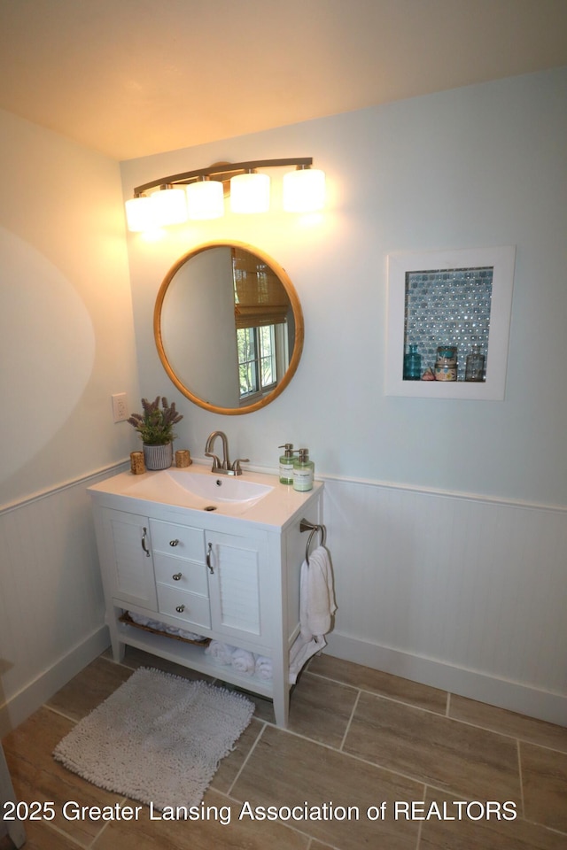 1615 Peppertree Ln, Lansing, MI 48912 - bathroom featuring vanity and a wainscoted wall