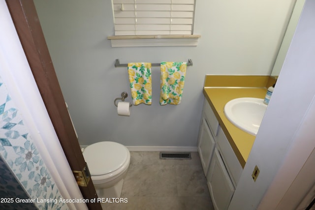 1615 Peppertree Ln, Lansing, MI 48912 - bathroom featuring vanity, toilet, and baseboards