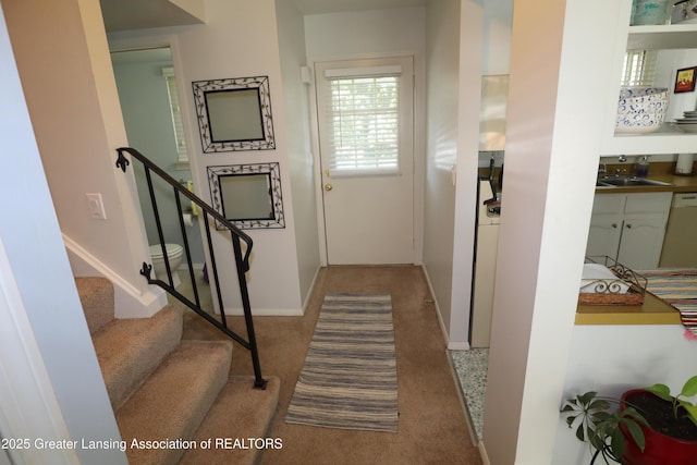 1615 Peppertree Ln, Lansing, MI 48912 - corridor featuring carpet floors, a sink, stairway, and baseboards