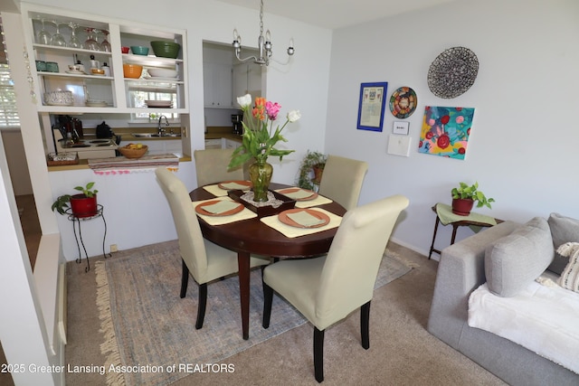 1615 Peppertree Ln, Lansing, MI 48912 - dining room featuring a chandelier and carpet flooring