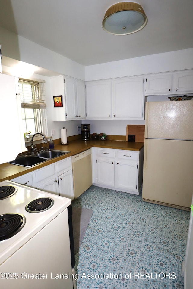 1615 Peppertree Ln, Lansing, MI 48912 - kitchen featuring white appliances, white cabinetry, a sink, and dark countertops