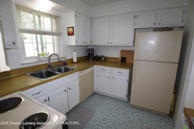 1615 Peppertree Ln, Lansing, MI 48912 - kitchen with white appliances, a sink, white cabinets, light countertops, and light flooring