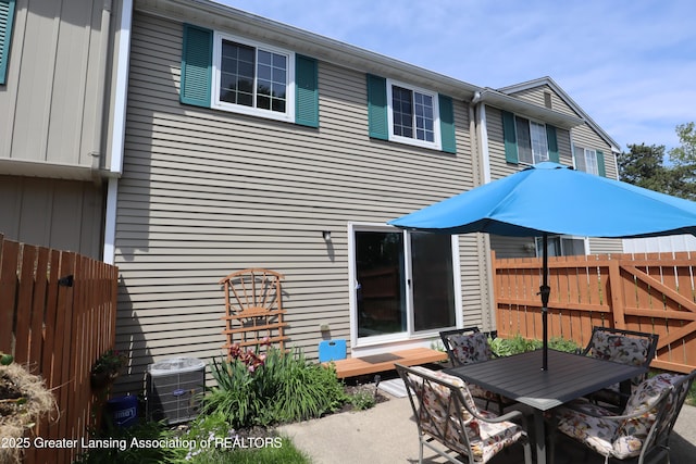1615 Peppertree Ln, Lansing, MI 48912 - rear view of house featuring outdoor dining area, a patio, and central AC unit