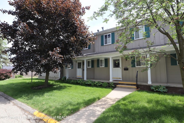 1615 Peppertree Ln, Lansing, MI 48912 - view of front of house with a porch, board and batten siding, and a front lawn