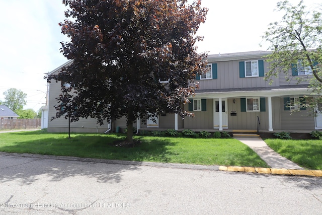 1615 Peppertree Ln, Lansing, MI 48912 - view of front facade featuring a porch and board and batten siding