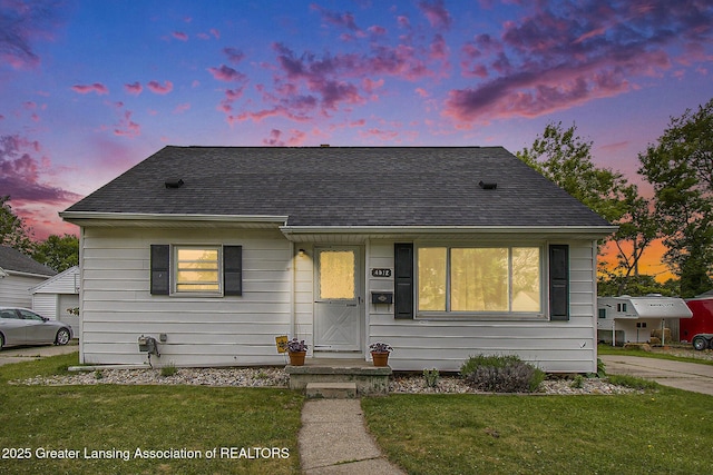 4512 Alpha St, Lansing, MI 48910 - view of front of house featuring a shingled roof and a yard