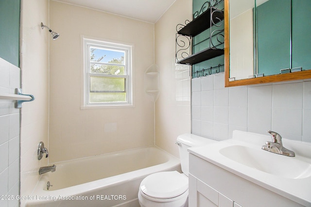 4512 Alpha St, Lansing, MI 48910 - bathroom featuring toilet, bathtub / shower combination, vanity, tile walls, and decorative backsplash