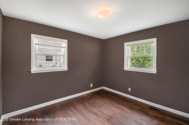 4512 Alpha St, Lansing, MI 48910 - empty room featuring baseboards and dark wood-type flooring