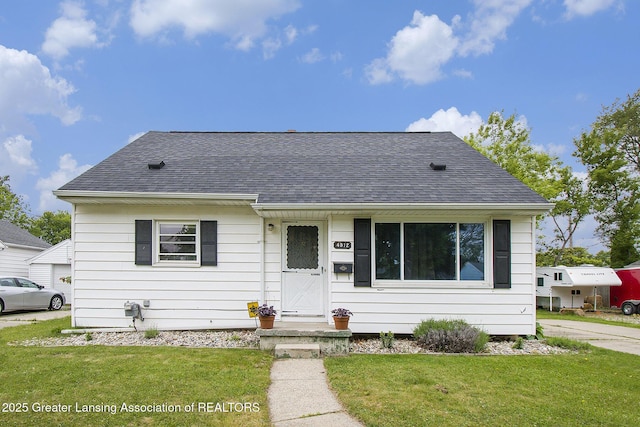 4512 Alpha St, Lansing, MI 48910 - view of front of house with roof with shingles and a front lawn