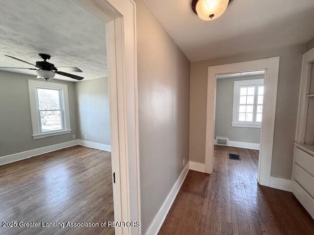 1305 W Hillsdale St, Lansing, MI 48915 - hall with dark wood-style flooring and baseboards