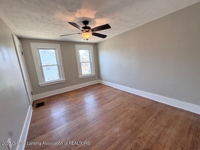 1305 W Hillsdale St, Lansing, MI 48915 - spare room featuring baseboards, wood finished floors, ceiling fan, and a textured ceiling