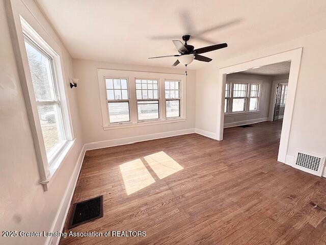 1305 W Hillsdale St, Lansing, MI 48915 - empty room with baseboards, dark wood-style flooring, and a ceiling fan