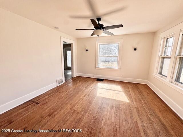 1305 W Hillsdale St, Lansing, MI 48915 - empty room with wood finished floors, baseboards, and a ceiling fan