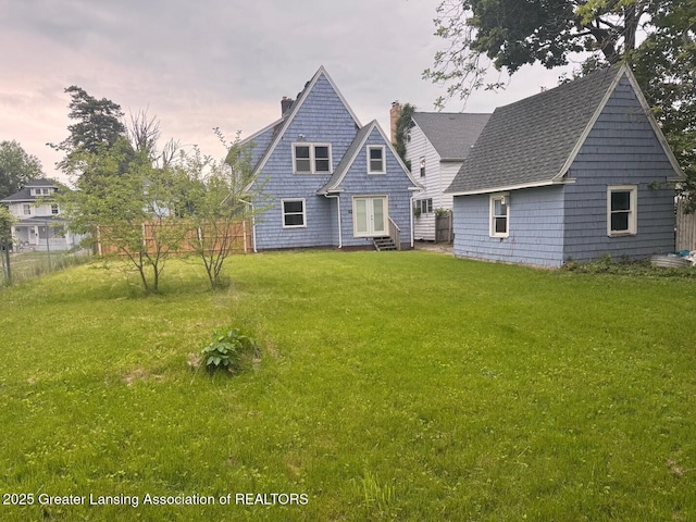 1305 W Hillsdale St, Lansing, MI 48915 - back of house with entry steps, french doors, and a chimney