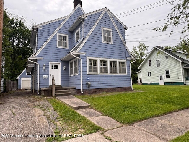 1305 W Hillsdale St, Lansing, MI 48915 - view of front facade with a chimney, a front lawn, and an outdoor structure