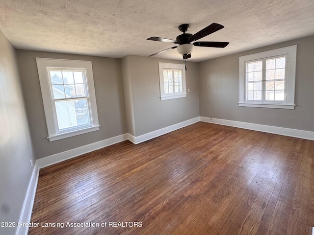 1305 W Hillsdale St, Lansing, MI 48915 - unfurnished room featuring dark wood-style floors, a textured ceiling, baseboards, and ceiling fan