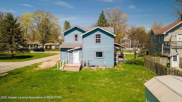 309 W Plain St, Eaton Rapids, MI 48827 - back of house with a chimney