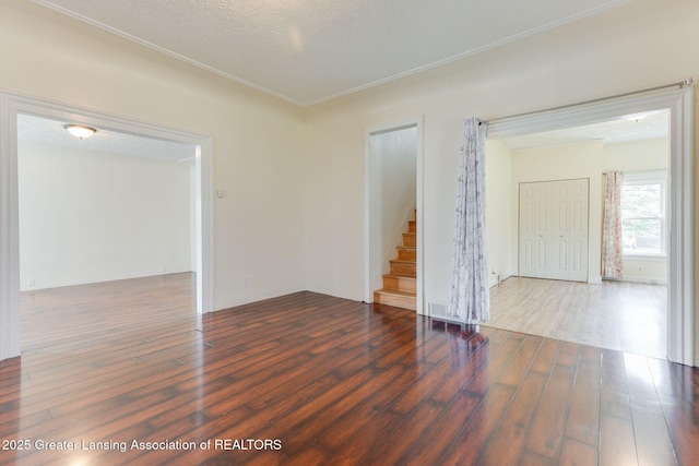 309 W Plain St, Eaton Rapids, MI 48827 - empty room featuring wood finished floors and stairs