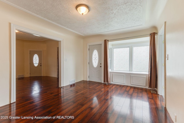 309 W Plain St, Eaton Rapids, MI 48827 - entryway featuring a textured ceiling and hardwood / wood-style floors