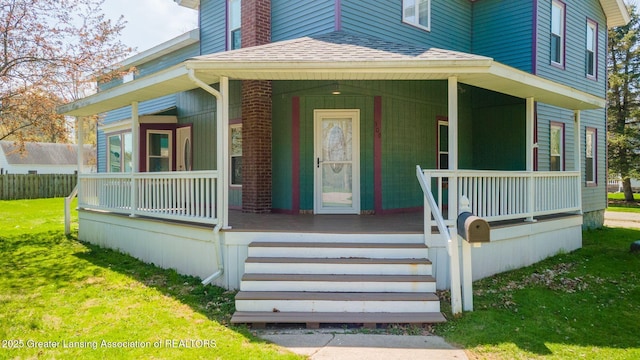 309 W Plain St, Eaton Rapids, MI 48827 - doorway to property featuring covered porch, roof with shingles, and a yard