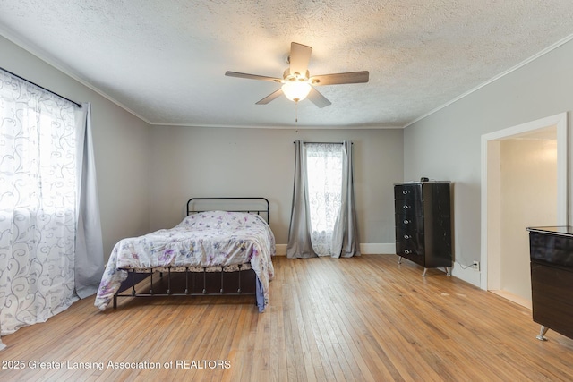 309 W Plain St, Eaton Rapids, MI 48827 - bedroom with wood-type flooring, a textured ceiling, ornamental molding, and ceiling fan