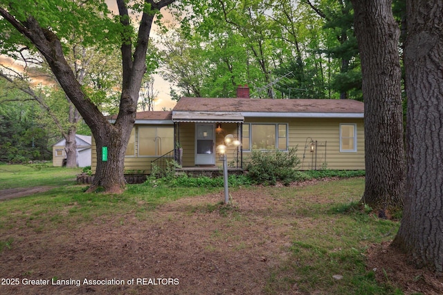 3105 Allen Ln, Harrison, MI 48625 - ranch-style house featuring a chimney