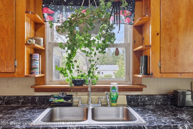 3105 Allen Ln, Harrison, MI 48625 - kitchen with a sink, dark countertops, backsplash, and plenty of natural light