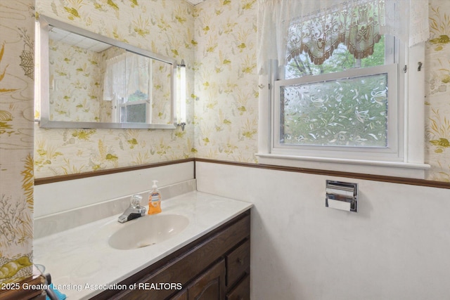 3105 Allen Ln, Harrison, MI 48625 - bathroom featuring vanity, plenty of natural light, and wallpapered walls