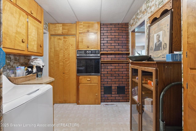 3105 Allen Ln, Harrison, MI 48625 - kitchen with oven, washer / clothes dryer, and light floors