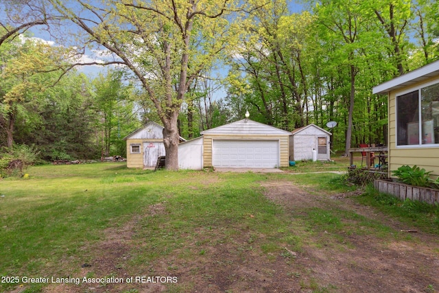 3105 Allen Ln, Harrison, MI 48625 - view of green lawn featuring an outbuilding and a detached garage