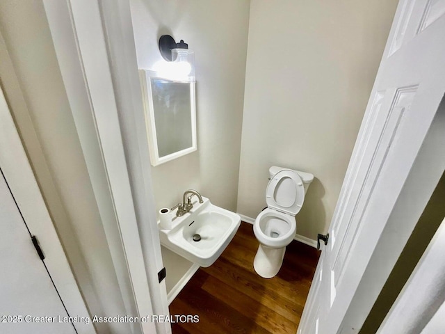 4408 Arbor Dr, Okemos, MI 48864 - half bathroom with toilet, wood finished floors, and baseboards