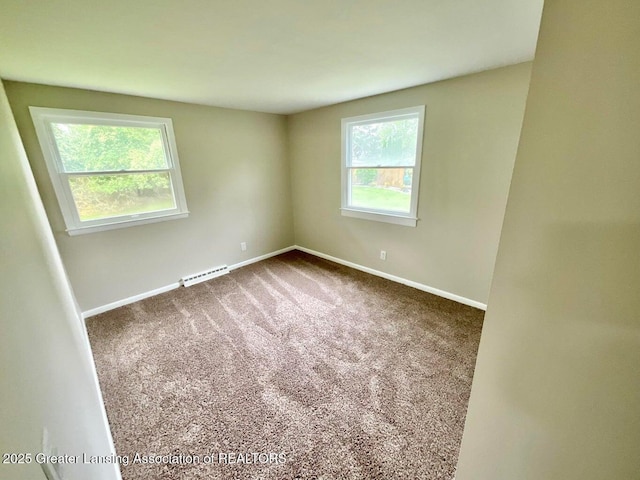 4408 Arbor Dr, Okemos, MI 48864 - empty room with baseboards, dark carpet, and a baseboard radiator