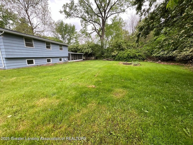 4408 Arbor Dr, Okemos, MI 48864 - view of grassy yard with a sunroom