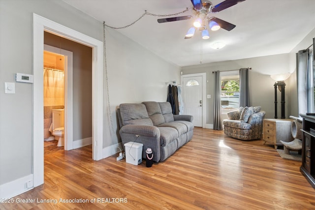3804 Glenwood Ave, Lansing, MI 48910 - living area with wood finished floors, a ceiling fan, and baseboards