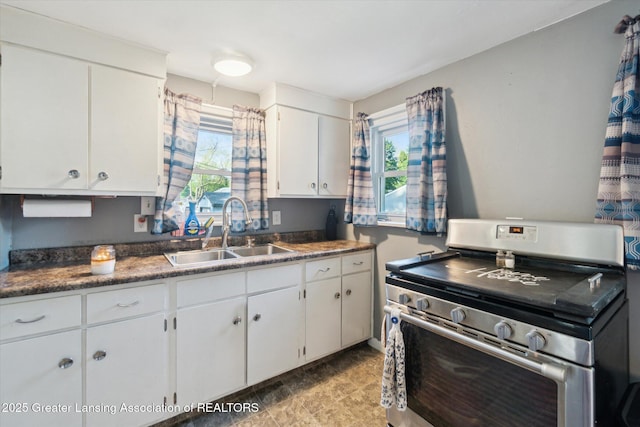 3804 Glenwood Ave, Lansing, MI 48910 - kitchen with a sink, stainless steel electric stove, white cabinets, and plenty of natural light