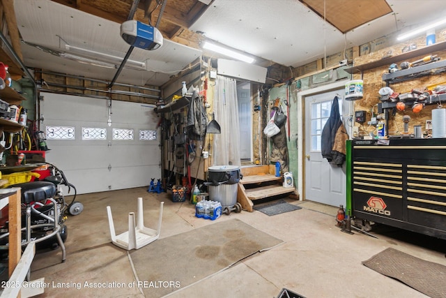 3804 Glenwood Ave, Lansing, MI 48910 - garage with a garage door opener and a workshop area