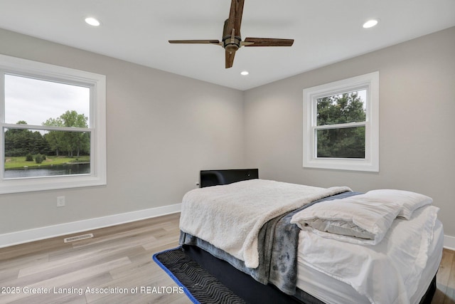 3115 Dietz Rd, Williamston, MI 48895 - bedroom with recessed lighting, light wood-type flooring, baseboards, and ceiling fan