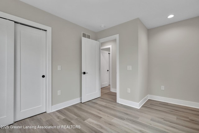 3115 Dietz Rd, Williamston, MI 48895 - unfurnished bedroom featuring light wood-style flooring, recessed lighting, baseboards, and a closet