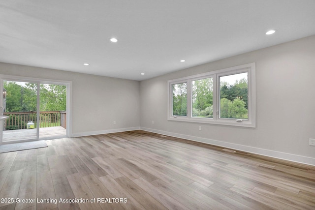 3115 Dietz Rd, Williamston, MI 48895 - unfurnished room featuring healthy amount of natural light, baseboards, light wood finished floors, and recessed lighting
