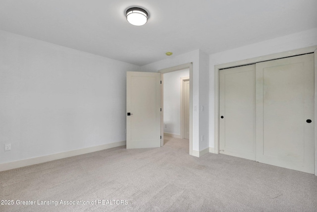 3115 Dietz Rd, Williamston, MI 48895 - unfurnished bedroom featuring carpet floors, a closet, and baseboards