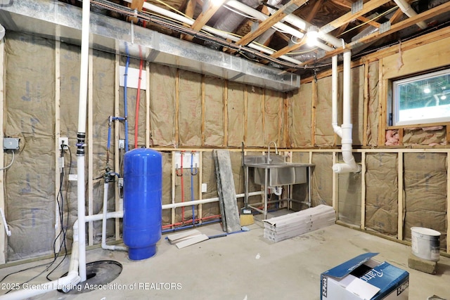 3115 Dietz Rd, Williamston, MI 48895 - below grade area with a water pressure tank and a sink
