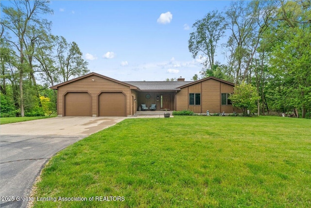 4582 N Watson Rd, Elsie, MI 48831 - view of front of house with an attached garage, a front yard, driveway, and a chimney
