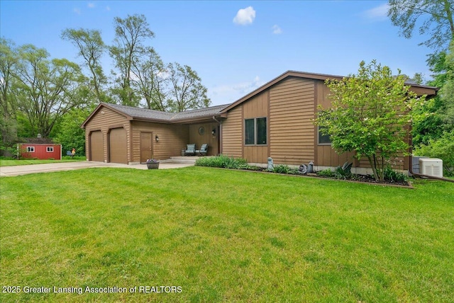 4582 N Watson Rd, Elsie, MI 48831 - view of front of property featuring driveway, an attached garage, and a front lawn